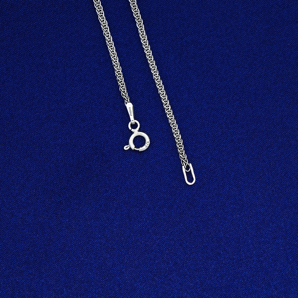 Silver chain necklace on a blue background