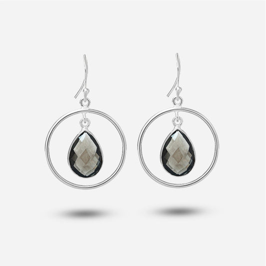 Silver hoop earrings with teardrop-shaped gemstones on a white background