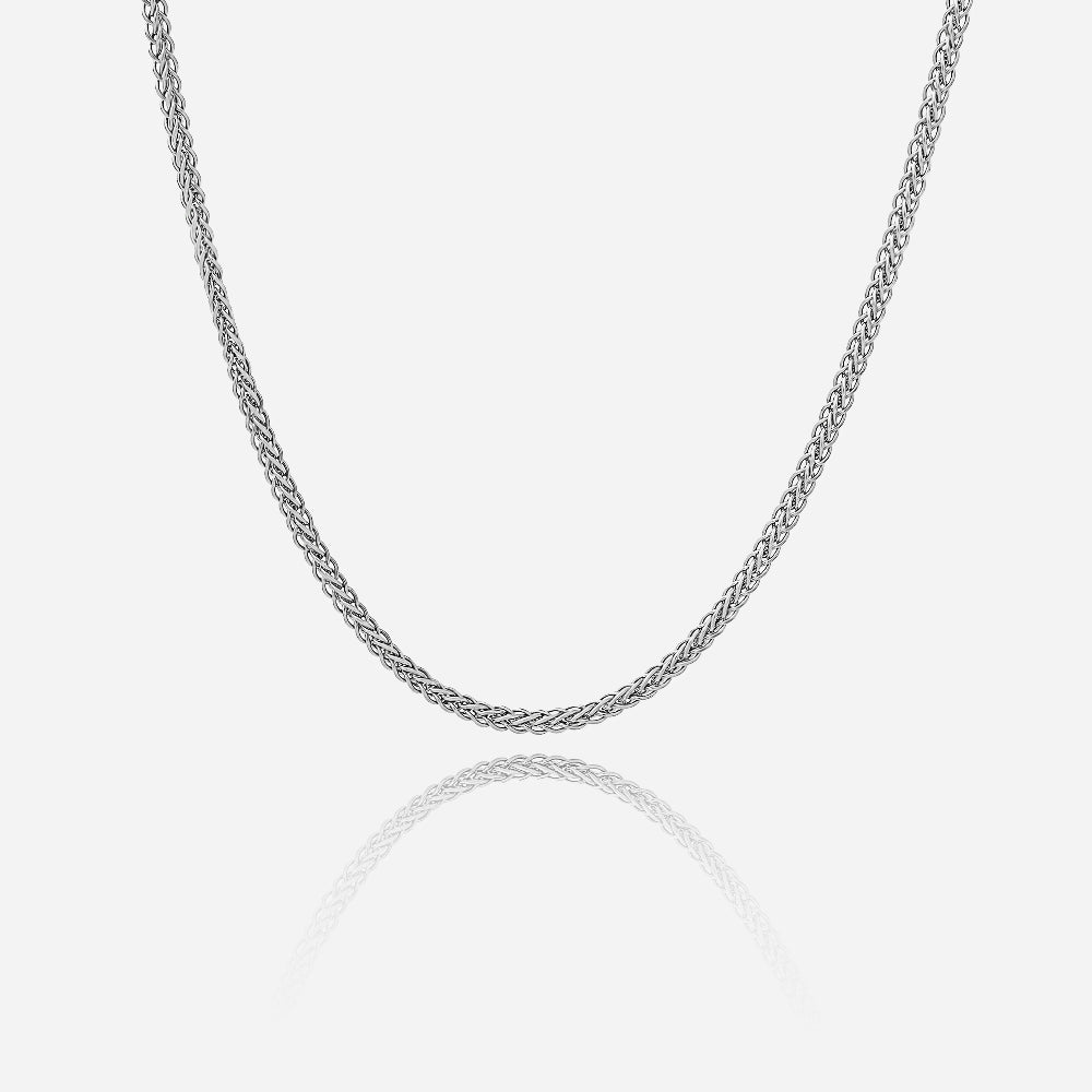 Silver chain necklace on a light gray background