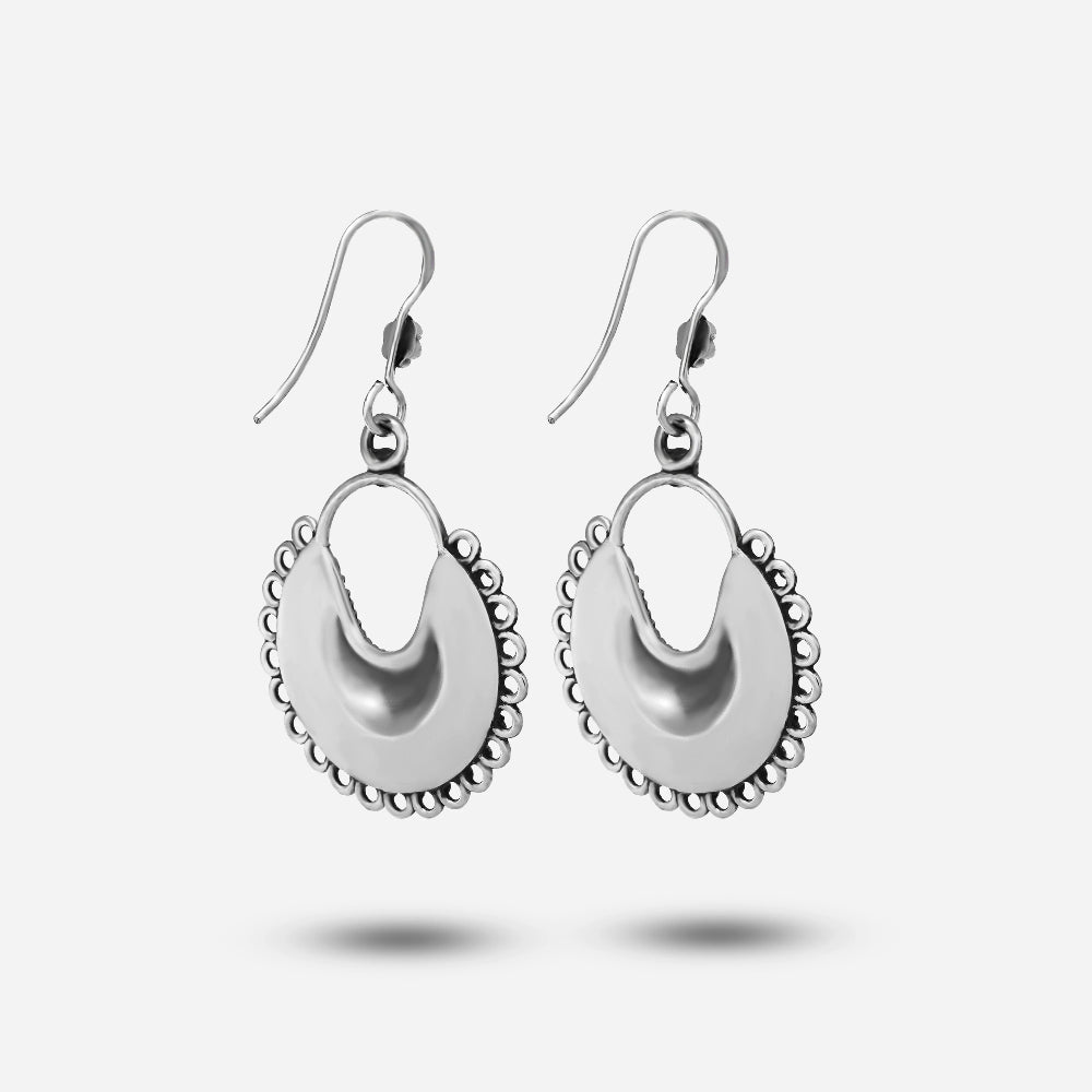 Pair of silver moon earrings on a white background