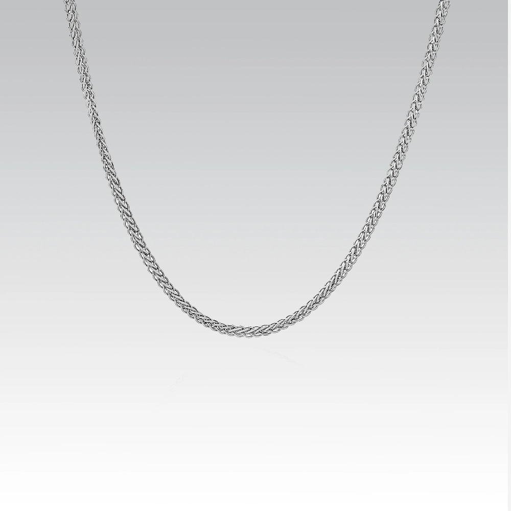 Silver chain necklace on a light gray background