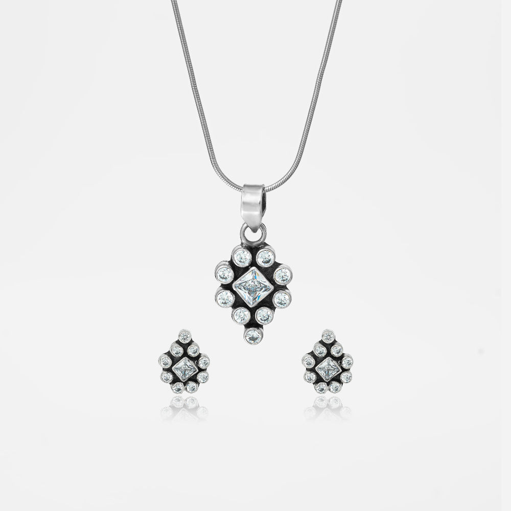 Silver jewelry set with pendant and earrings.
