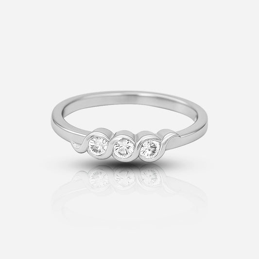 Silver ring with three diamonds on a light gray background