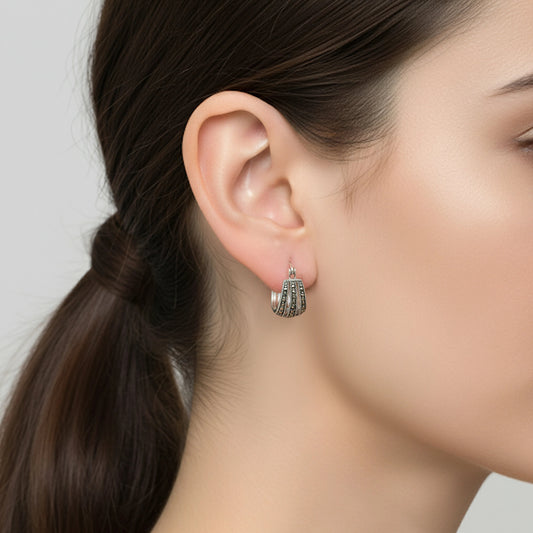 Close-up of a woman wearing silver hoop earrings by Silver World - Best silver shops in Delhi.