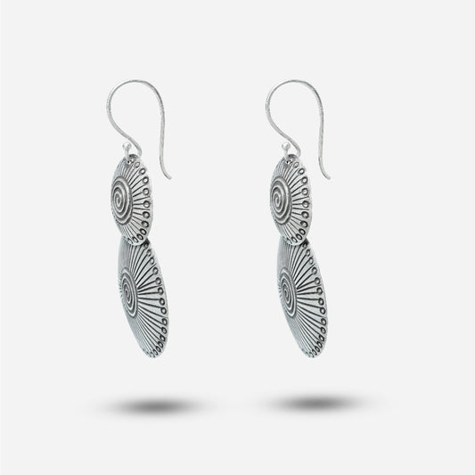 Pair of silver antique earrings on a white background