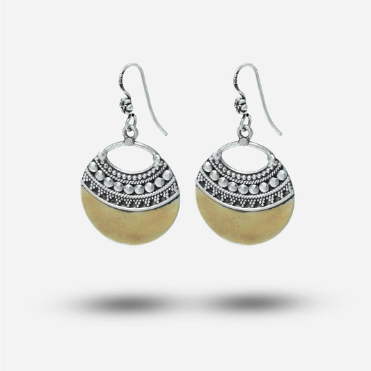 Pair of vintafge earrings with silver circular designs and beige beads on a white background