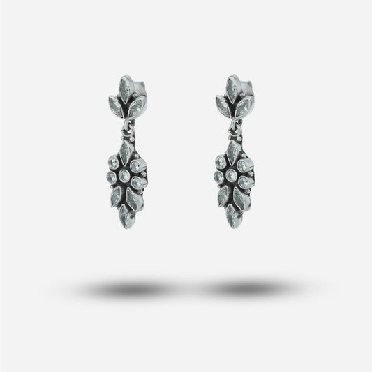 Pair of silver earrings with gemstones on a light gray background