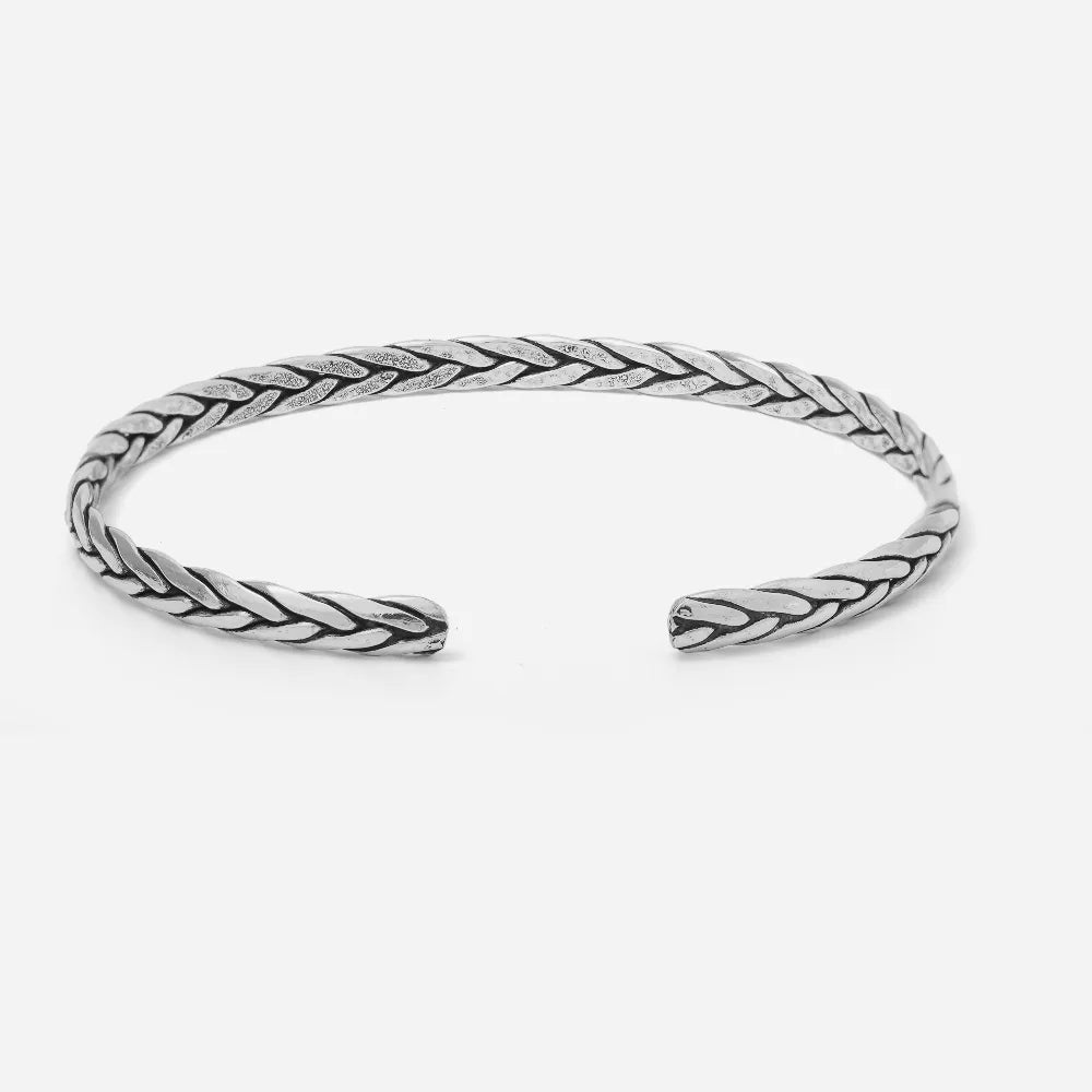 Silver braided bangle on a white background