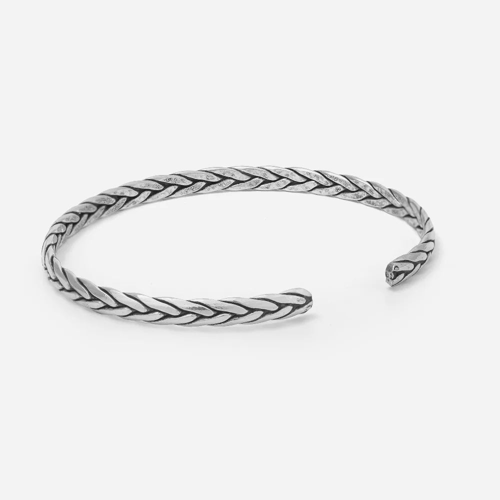 Silver braided bangle on a white background