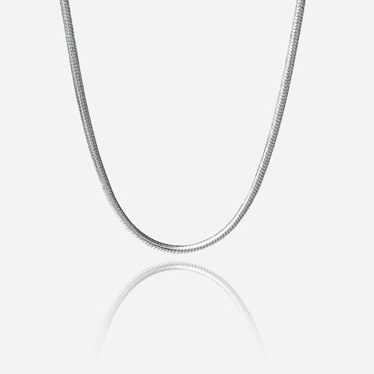 Silver snake chain necklace on a light gray background