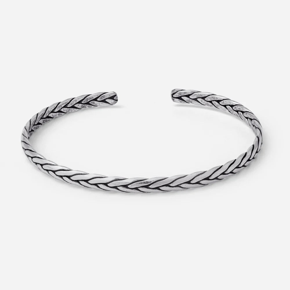Silver braided bangle on a white background
