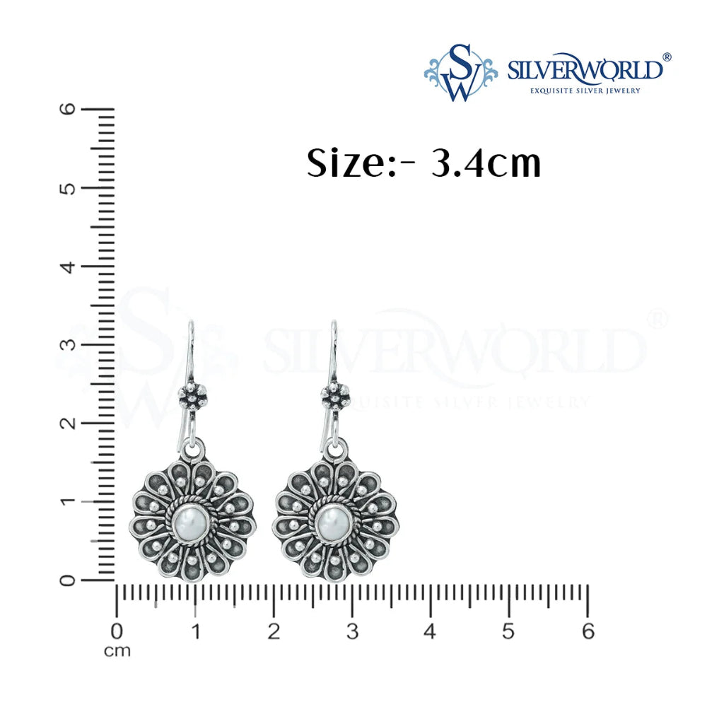 silver flower design earrings scale