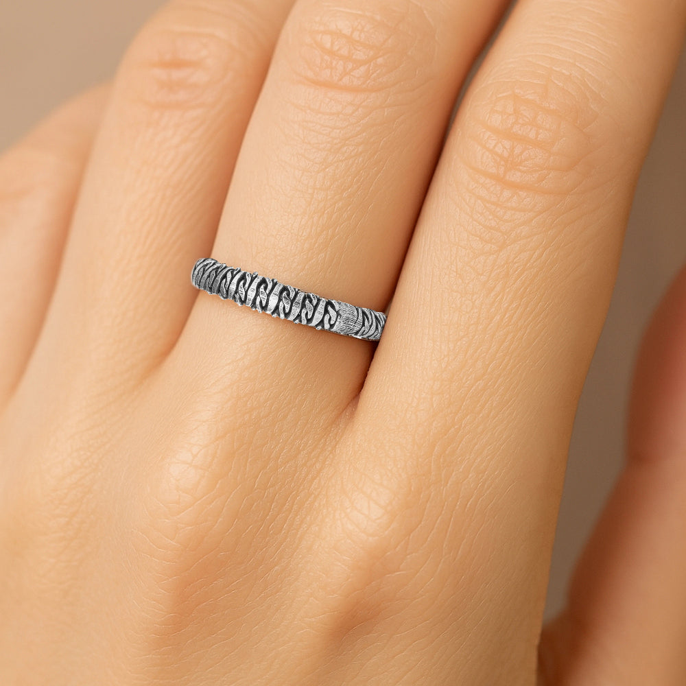 Silver ring with a textured band