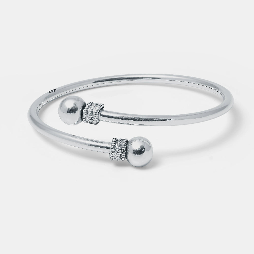 Silver bracelet with spherical beads on a white background