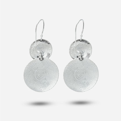 Pair of silver antique earrings on a white background