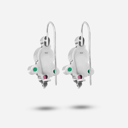 Pair of silver earrings with gemstone accents on a white background