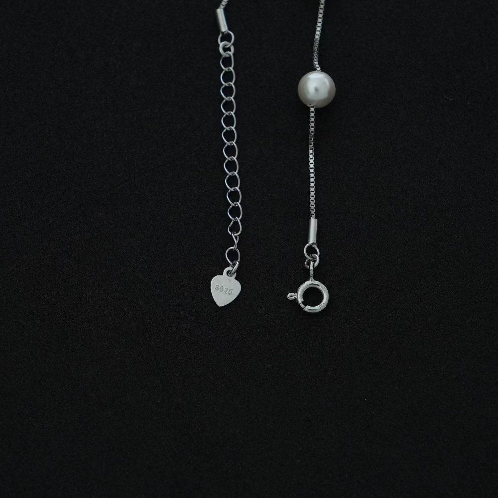 Silver pearl bracelet on a black background