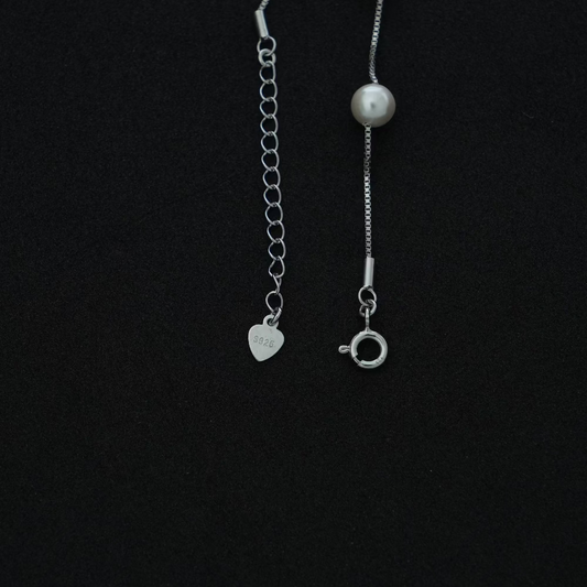 Silver pearl bracelet on a black background