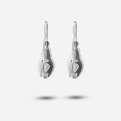 Pair of silver earrings on a light gray background