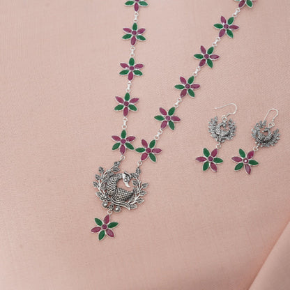 Jewelry set with necklace and earrings on a pink background