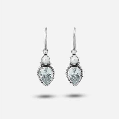 Pair of drop earrings with teardrop-shaped gemstones on a white background