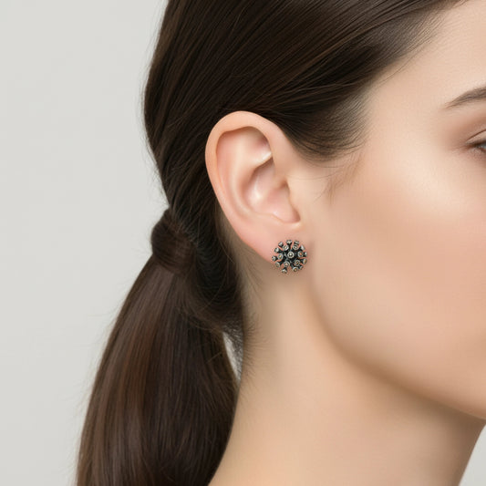Close-up of a woman wearing a floral earring by Silver World - best silver shops in Delhi.