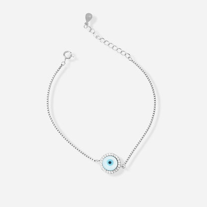 Silver bracelet with a blue evil eye charm on a white background