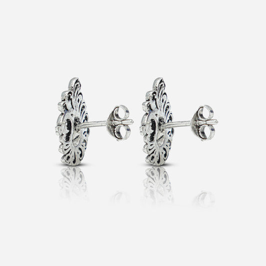 Pair of silver earrings with intricate designs 