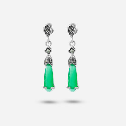 Pair of silver earrings with green teardrop-shaped stones on a white background