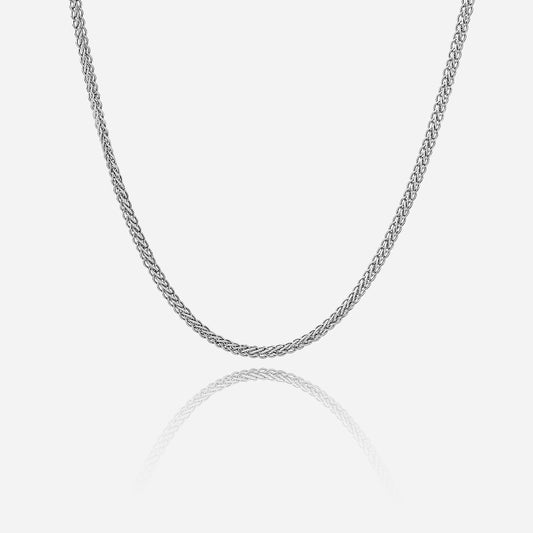 Silver chain necklace on a light gray background