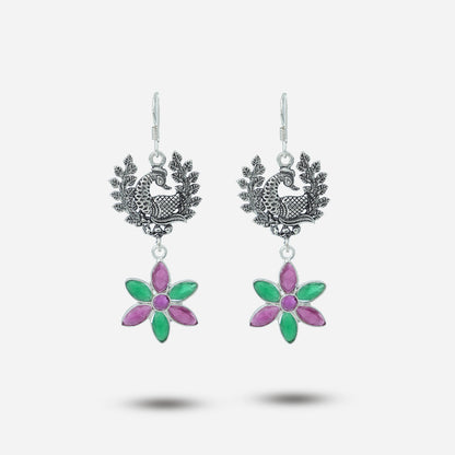 Pair of earrings with floral designs on a white background