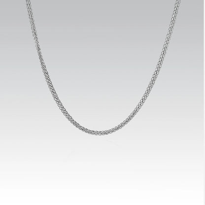Silver chain necklace on a light gray background