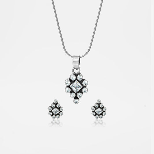 Silver jewelry set with pendant and earrings.