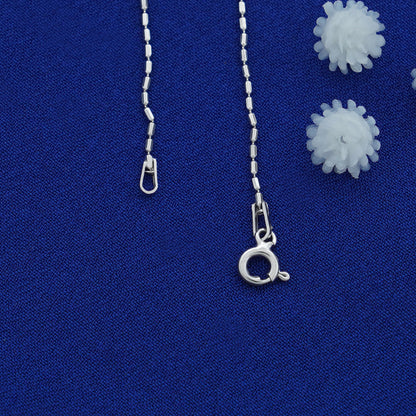 Silver necklace chain with clasp on a blue background
