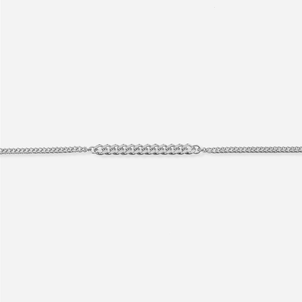Silver curb chain bracelet on a white background