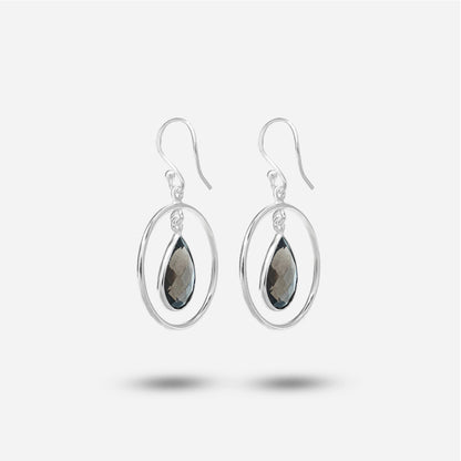 Pair of silver earrings with teardrop-shaped gemstones on a white background
