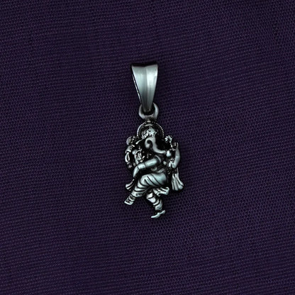 Ganesh Silver pendant with an elephant figure on a dark purple background