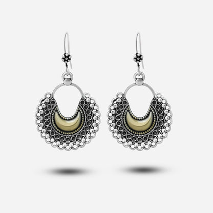 Pair of silver earrings with crescent moon design on a white background