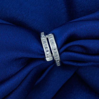 Silver spiral ring on a blue fabric background