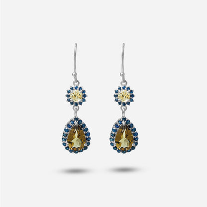 Pair of earrings with teardrop-shaped gemstones on a white background