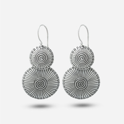 Pair of silver antique earrings on a light gray background