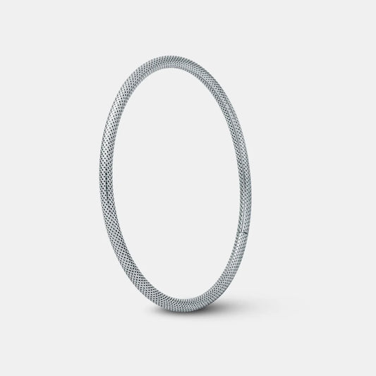 Silver bangle on a light gray background