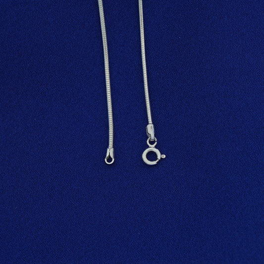 Silver necklace with clasp on a blue background