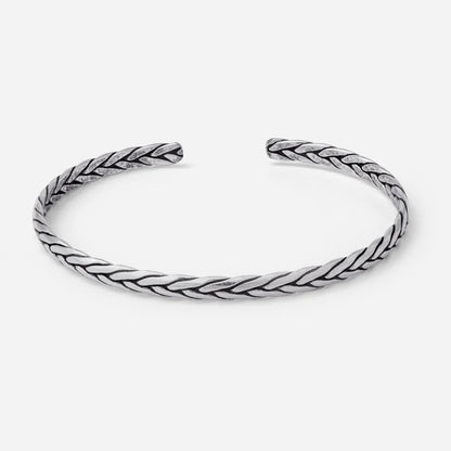 Silver braided bangle on a white background