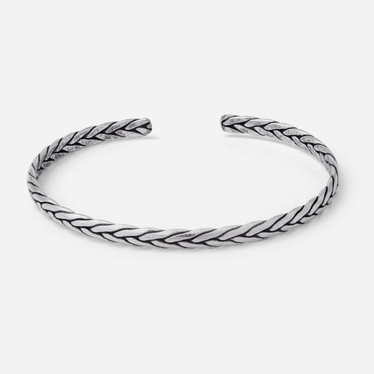Silver braided bangle on a white background