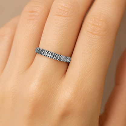 Silver ring with a textured band 