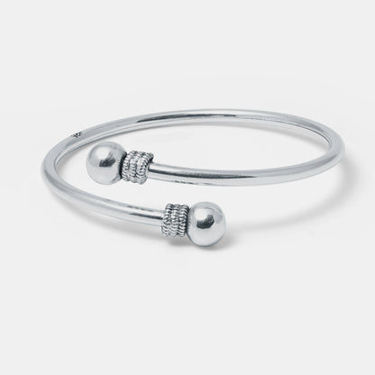 Silver bracelet with spherical beads on a white background