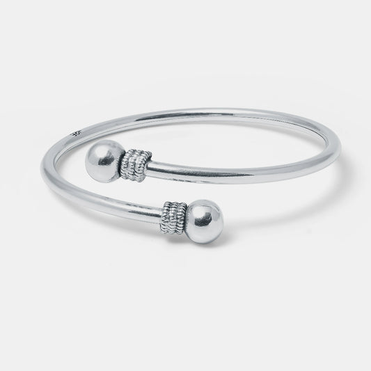 Silver bracelet with spherical beads on a white background
